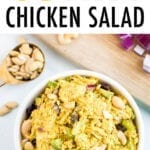Bowl of curry chicken salad made with raisins, celery, onion, and cashews.