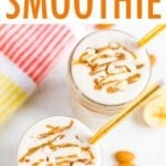Two banana almond butter smoothies with straws and topped with chopped almonds and an almond butter drizzle. Almonds, banana slices and a napkin are on the table.