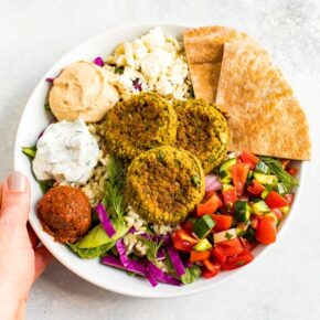 Falafel bowl with baked falafel, hummus, feta, pita, salad and rice.