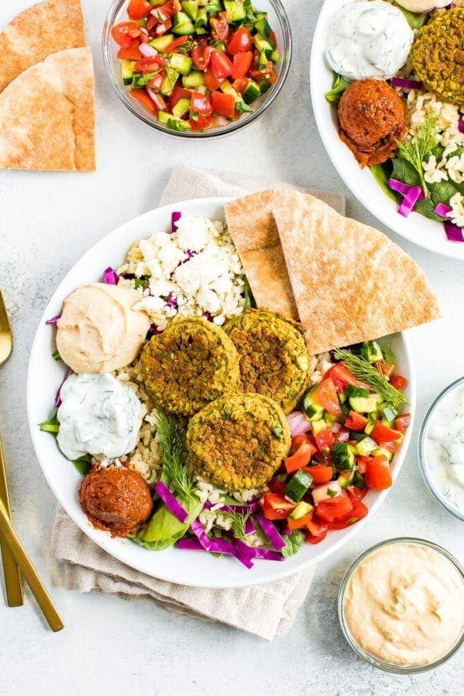 Falafel bowl with baked falafel, hummus, feta, pita, salad and rice.