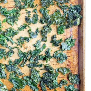 Kale chips baked on a tray.