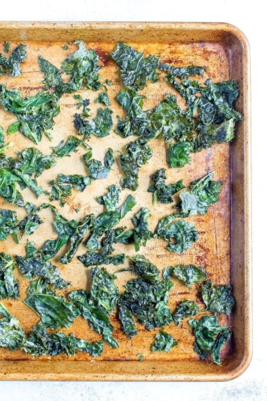 Kale chips baked on a tray.