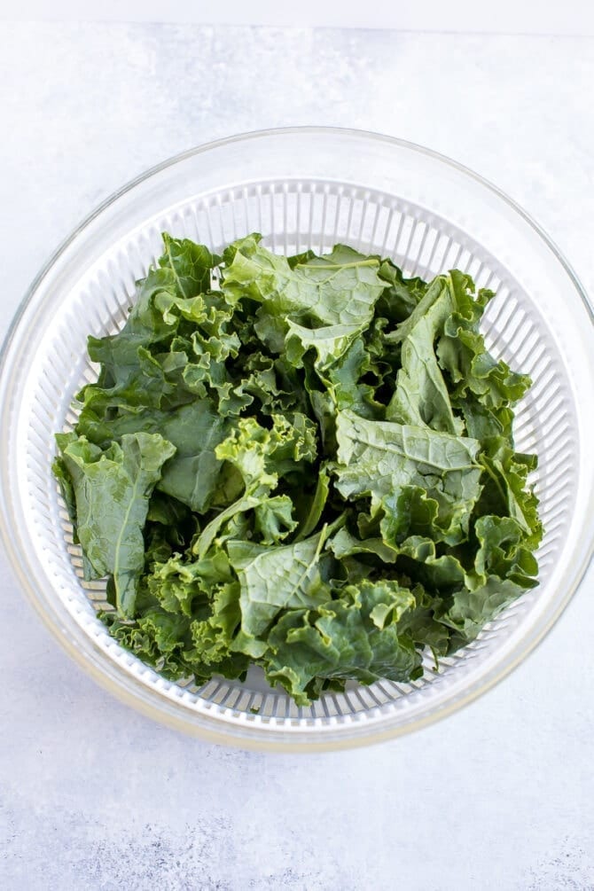 Salad spinner with kale inside.