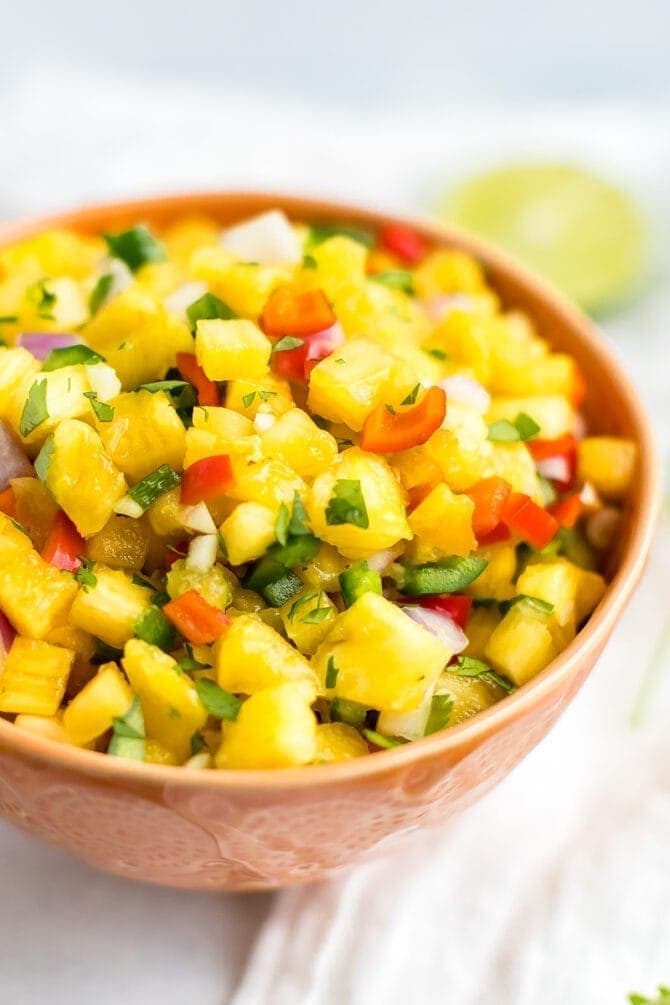 Bowl of pineapple salsa with onions and pepper.