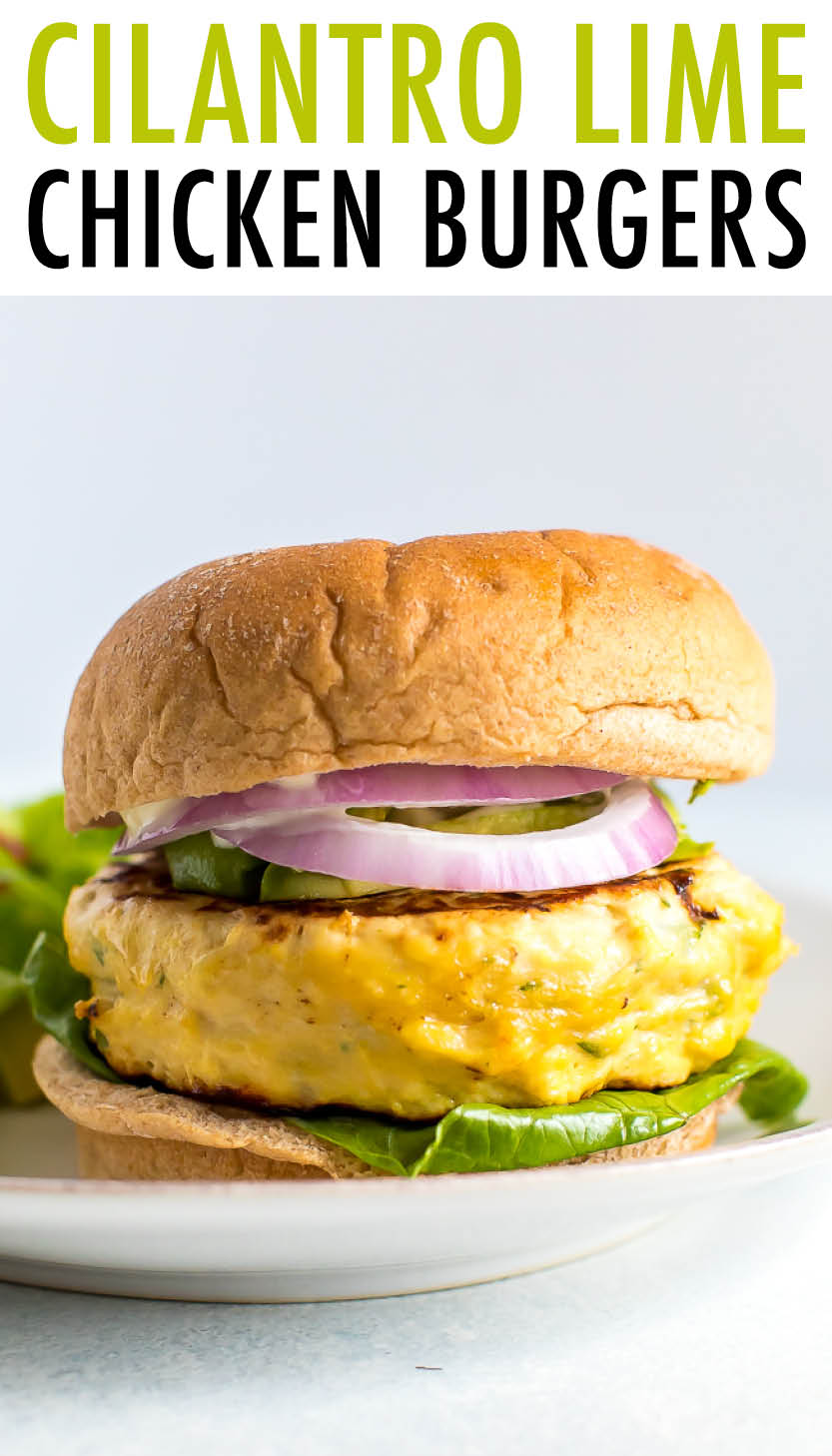Chicken burger on a bun with red onion, avocado, and lettuce.