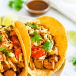 Three asian tofu tacos with baked teriyaki tofu, asian slaw, and cilantro.