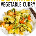 Summer vegetable curry served over rice and topped with fresh basil.