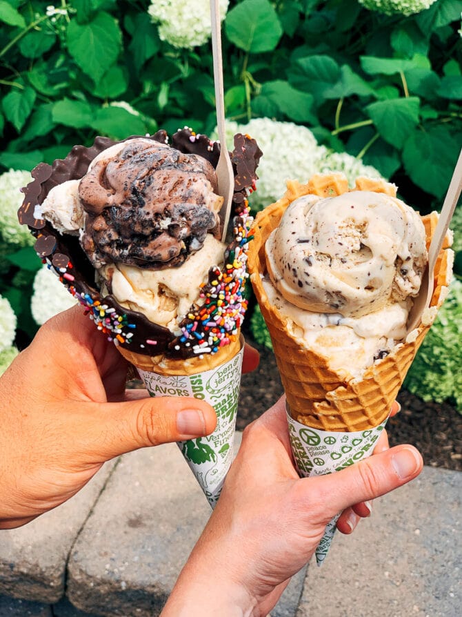Hands holding two Ben & Jerry's waffle cones.
