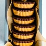 Stack of homemade peanut butter cups in parchment paper, in a bundt pan.