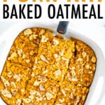 A spatula is lifting a slice of pumpkin baked oatmeal out of a baking dish.