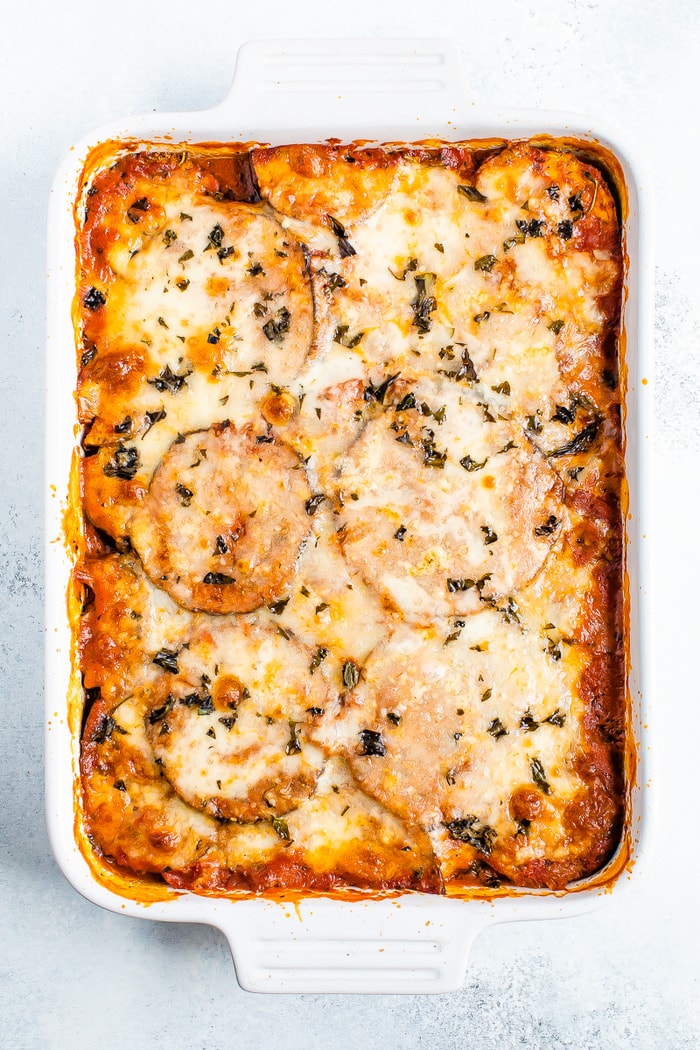 Cheesy baked eggplant parmesan in a casserole dish.