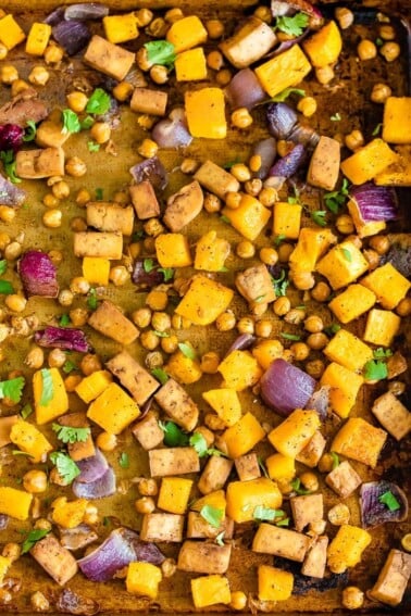 Sheet pan with roasted red onion, butternut squash, chickpeas, and tofu.
