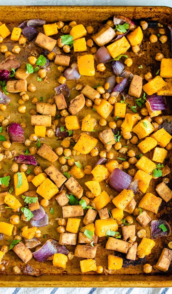 Sheet pan with roasted red onion, butternut squash, chickpeas, and tofu.