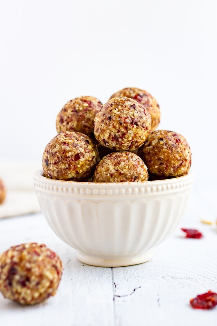 White bowl full of cranberry energy bites.