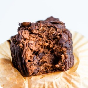 Double chocolate protein muffin with a bite taken out of it.