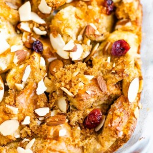 Top of a french toast bake, topped with brown sugar, cranberries, and almonds.