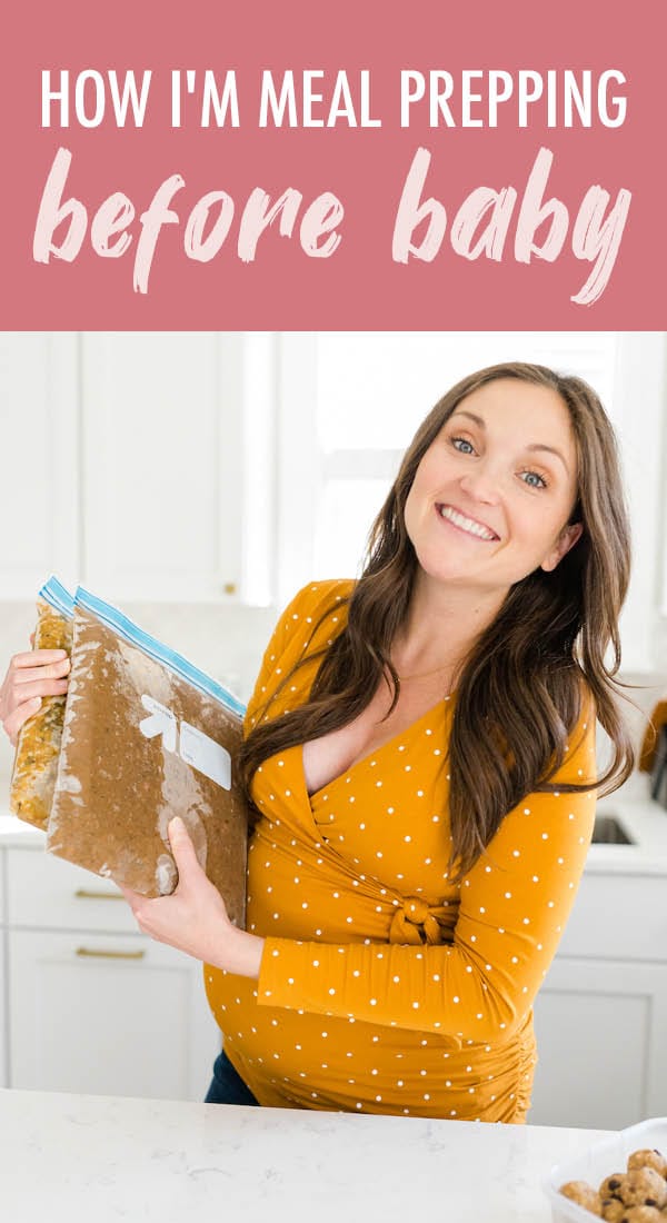 Pregnant woman holding freezer bags with meal prep freezer meals.