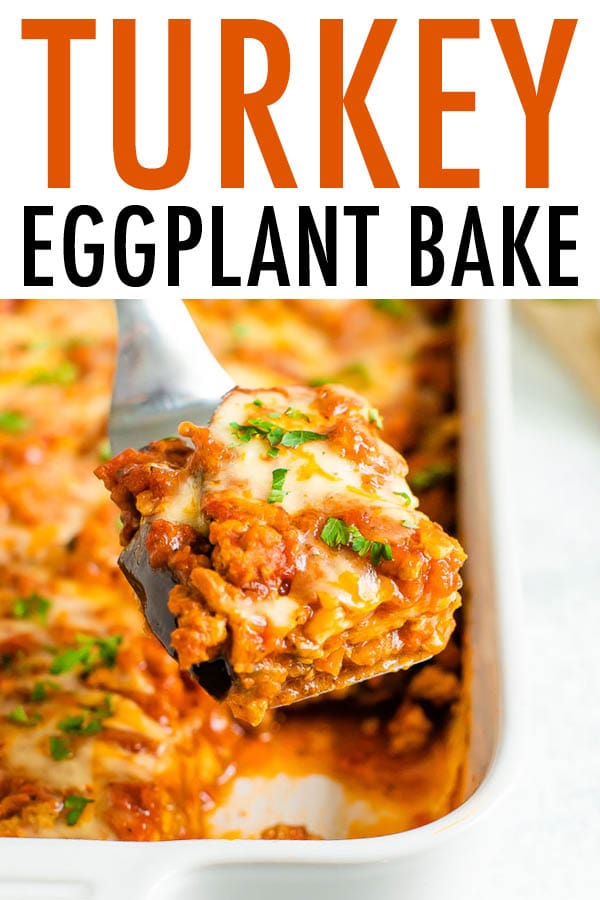 Spatula lifting a slice of eggplant turkey bake from a casserole dish.