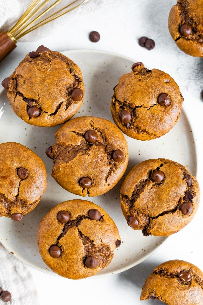 An overhead shot of a plate with 6 flourless muffins on it.