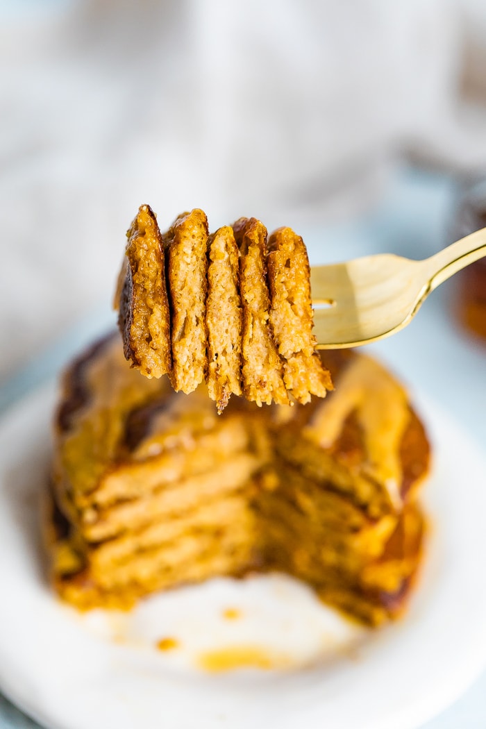 Fork with a slice of the stack of pumpkin pancakes.