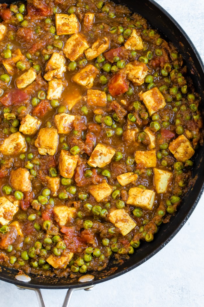 Pan full of mattar tofu-- tofu cooked in tomatoes and peas.