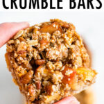 Hand holding an apple crumble bar.