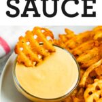 Waffle fry being dipped into homemade Chick-Fil-A Sauce.