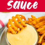 Waffle fry being dipped into homemade Chick-Fil-A Sauce.