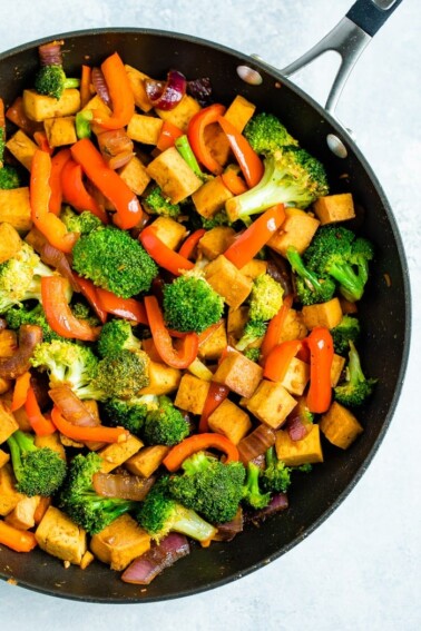 Frying pan with stir fries tofu and vegetables.