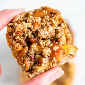 Hand holding an apple crumble bar.