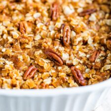Baking dish with sweet potato baked oatmeal topped with pecans.