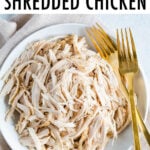 Plate with shredded chicken and two forks.