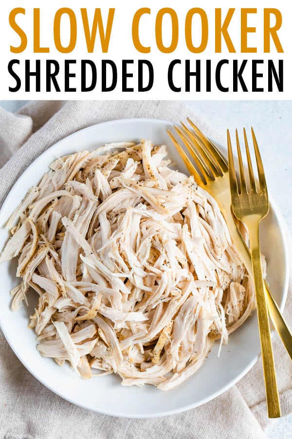Plate with shredded chicken and two forks.