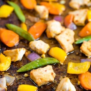 Sheet pan with roasted veggies and chicken with an asian sauce.