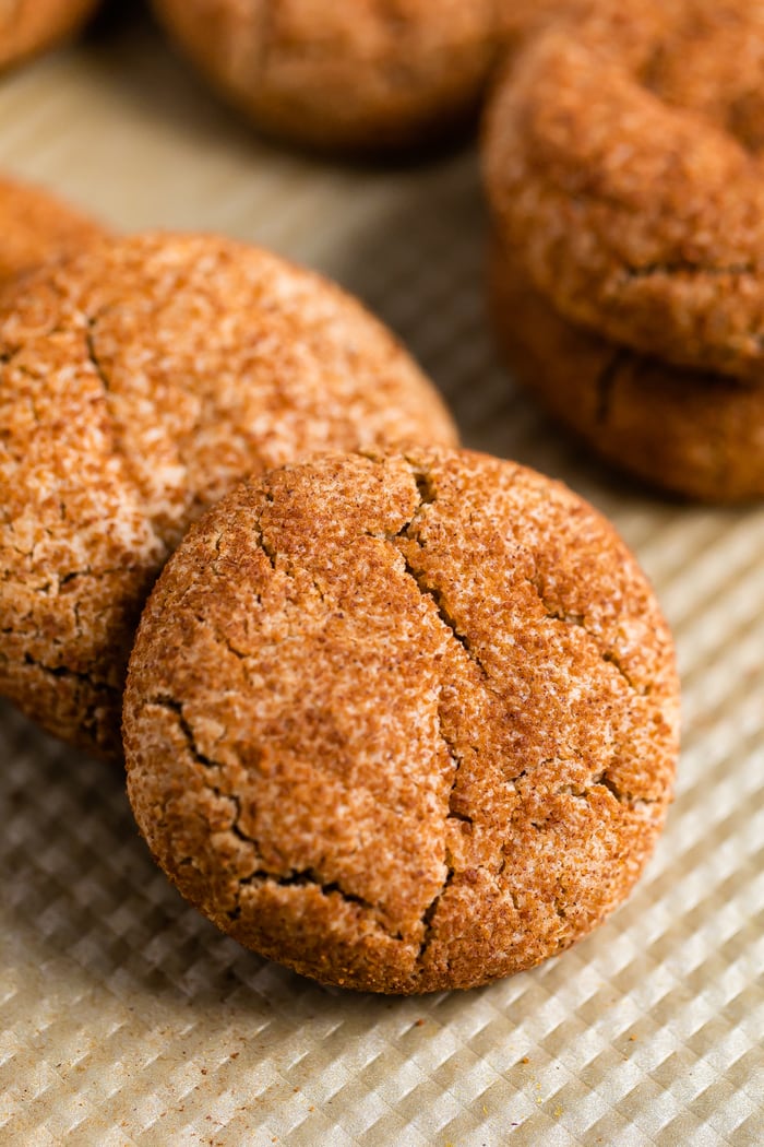 Healthy snickerdoodle cookies on a gold cookie tray.