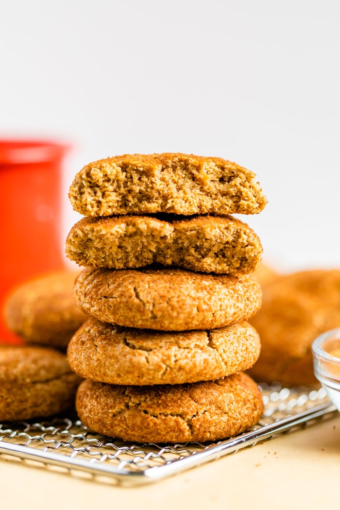 Stack of fluffy snickerdoodle cookies. The top two cookies are split in half.