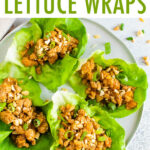 Four Asian chicken lettuce wraps on a plate.