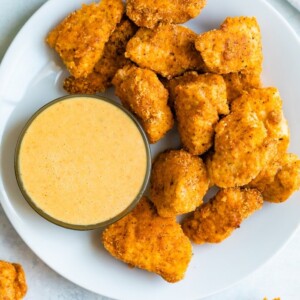 Plate with baked chicken nuggets and a dipping bowl with homemade Chick-Fil-A sauce.