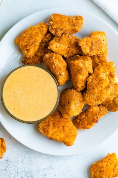 Plate with baked chicken nuggets and a dipping bowl with homemade Chick-Fil-A sauce.