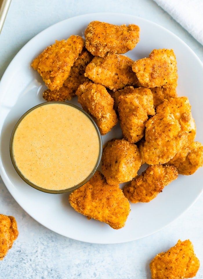Plate with baked chicken nuggets and a dipping bowl with homemade Chick-Fil-A sauce.