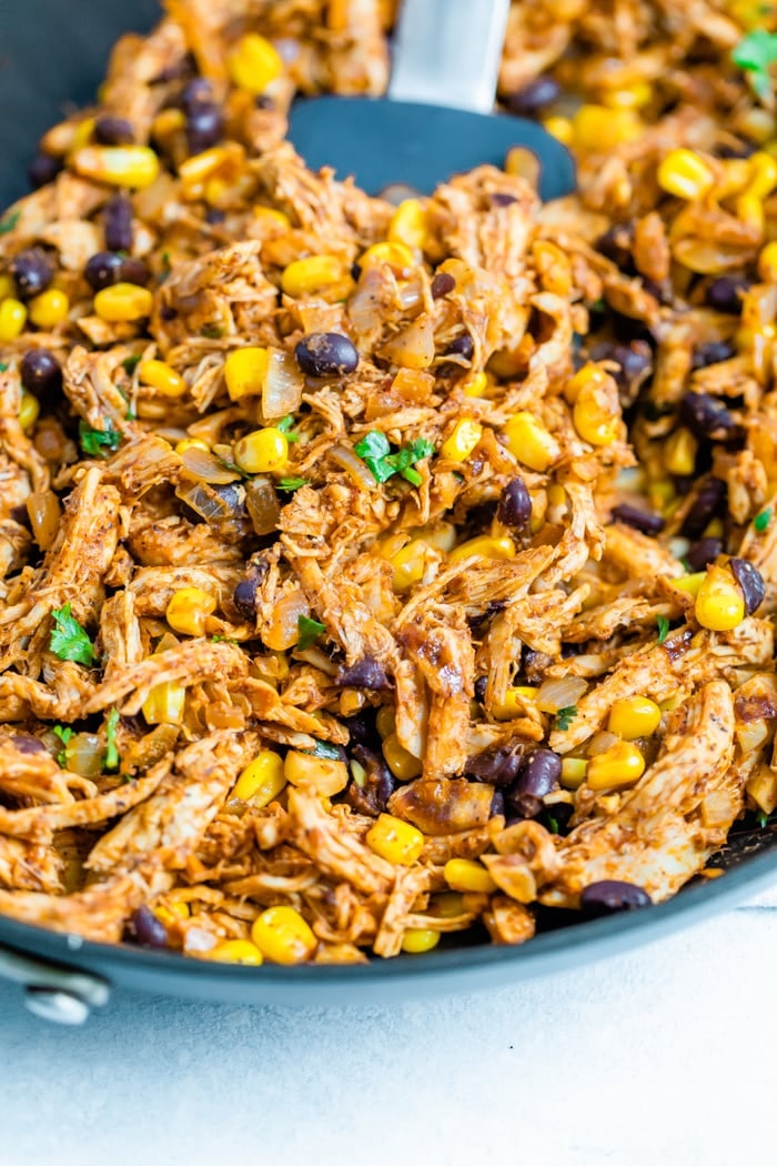 Chicken enchilada filling in a skillet.