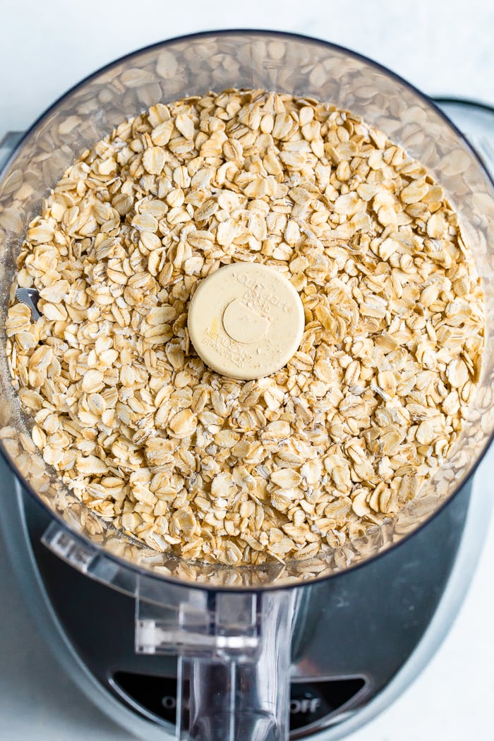 Food processor with rolled oats inside.