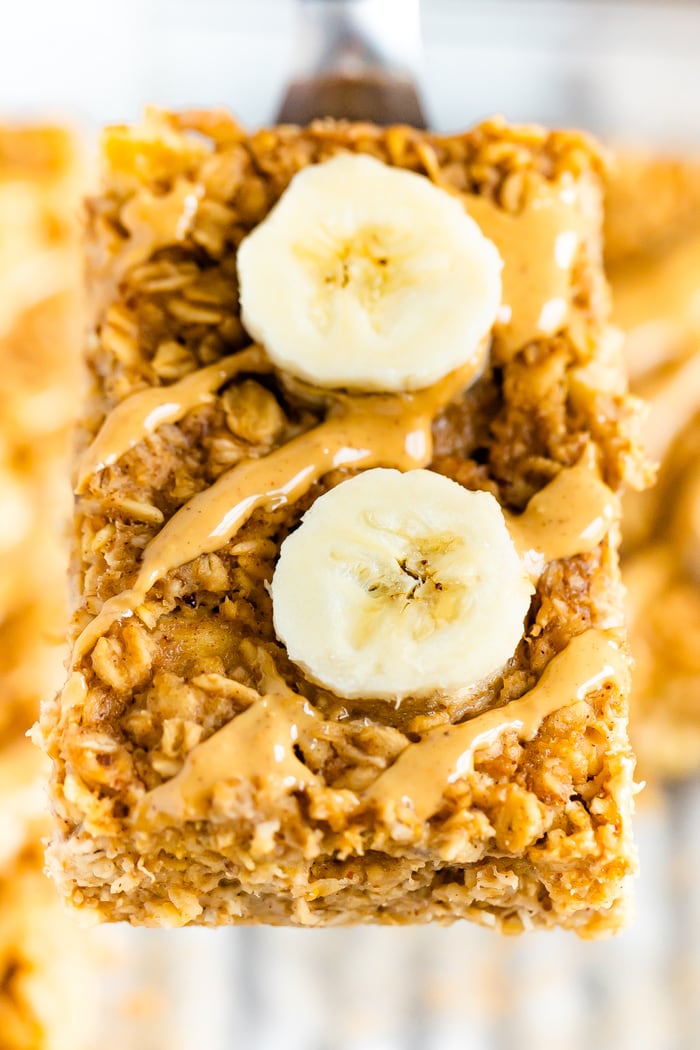 Spatula lifting a slice of peanut butter banana baked oatmeal.