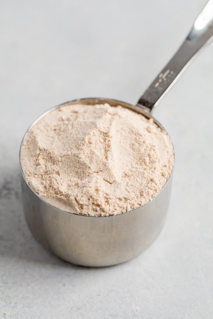 Measuring cup with whole wheat flour.