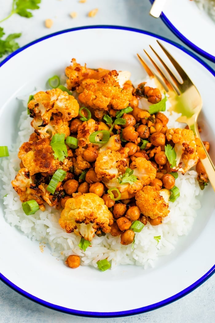 Plate of rice topped with roasted cauliflower and chickpeas.