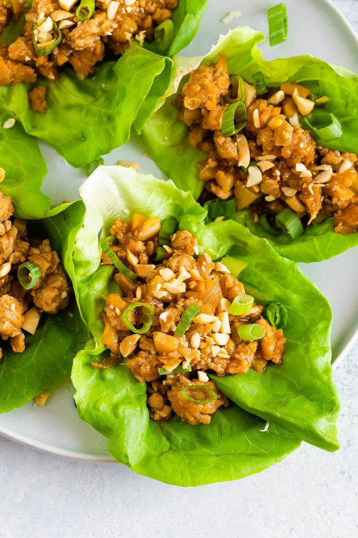 Four chicken lettuce wraps on a plate. 