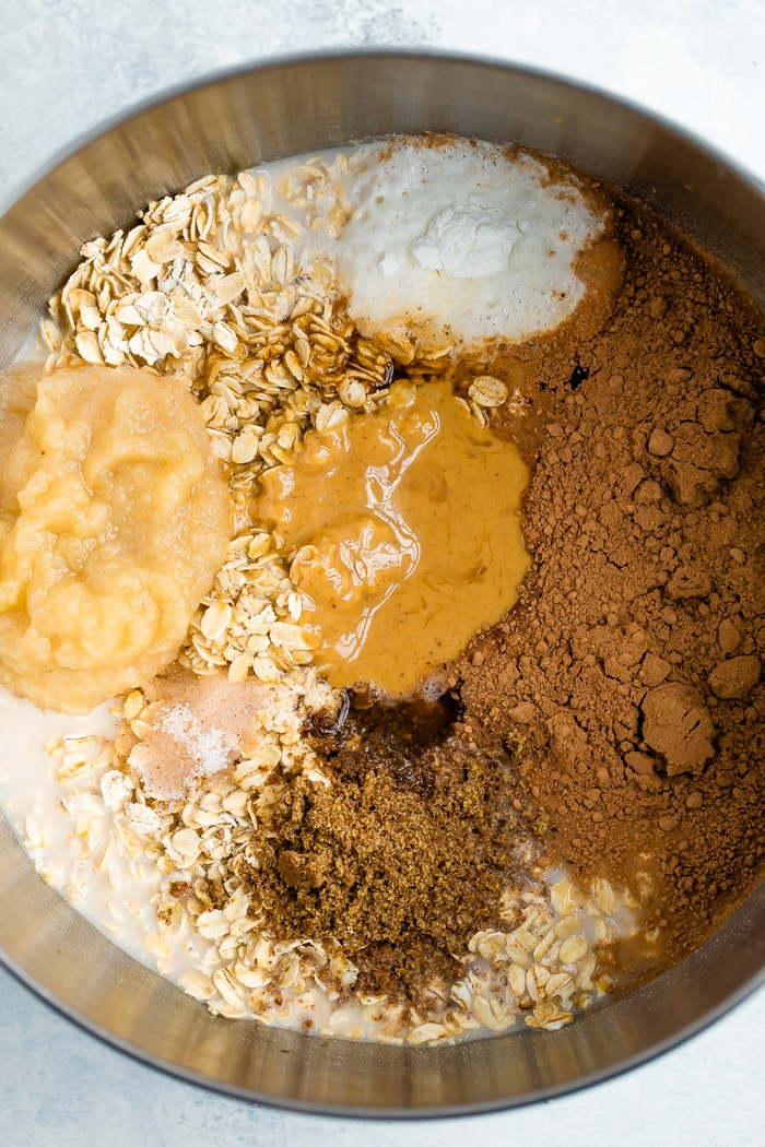 Mixing bowl with ingredients for chocolate peanut butter baked oatmeal.