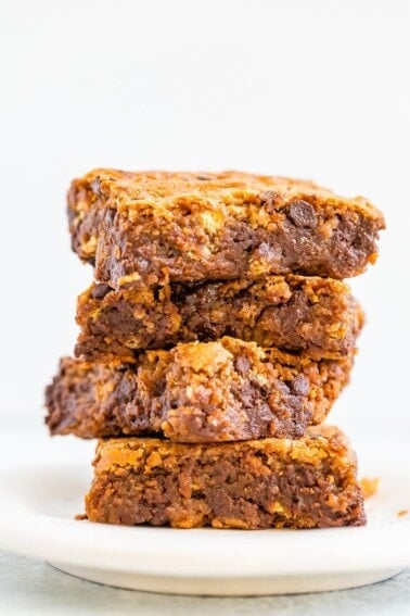 Stack of four gooey blondies with chocolate chips.