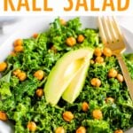 Kale salad topped with chickpeas and avocado.