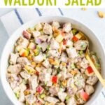 Creamy chicken waldorf salad in a bowl made with apples, celery, onions and walnuts.